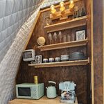 Kitchenette chaleureuse en cabane perchée, déco bois unique, appareils mint pour séjour insolite. Auberge de la Tuilière